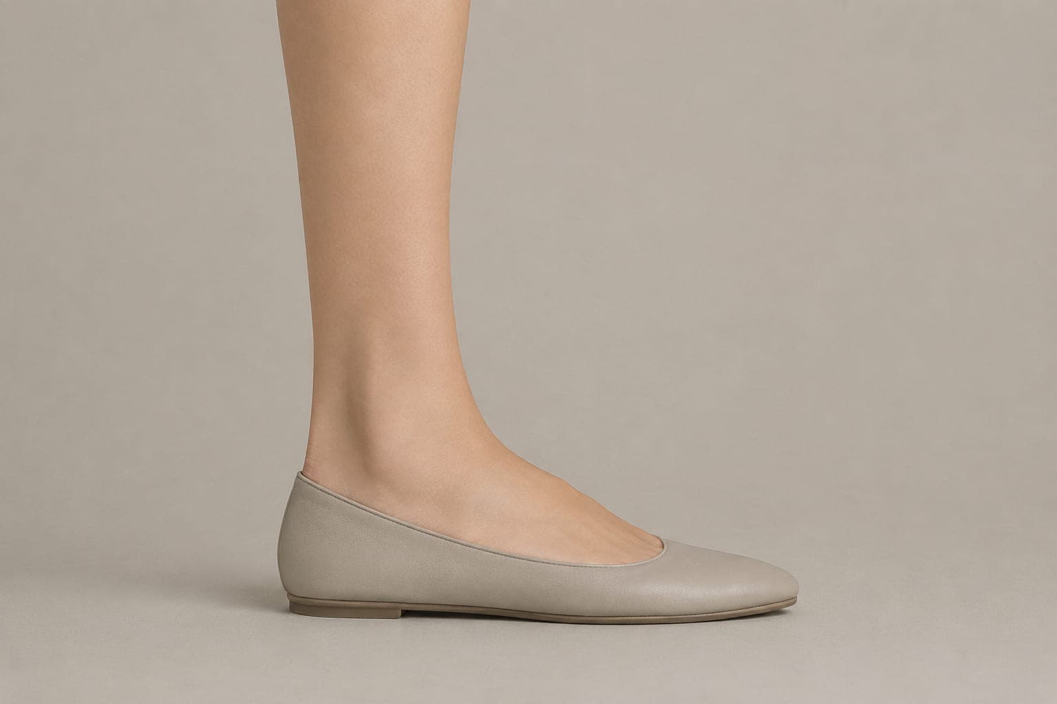 The same foot inside a shoe with an opening above the cuff height, showing no sock above the shoe.