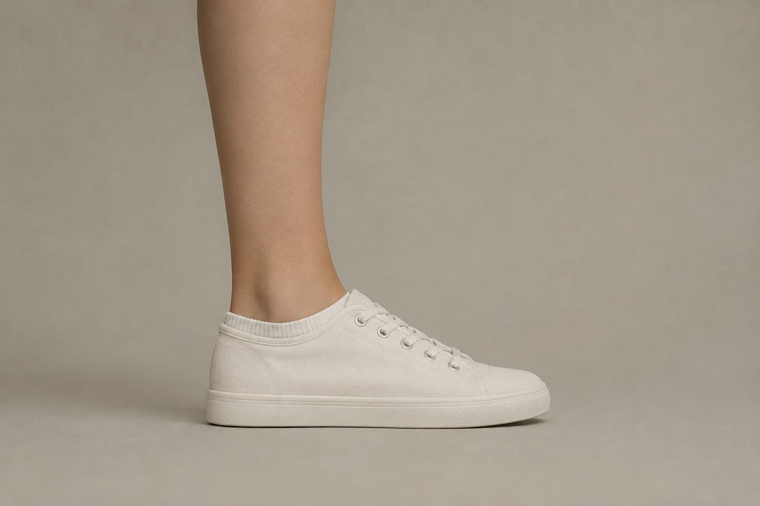 The same foot inside a shoe with an opening above the cuff height, showing no sock above the shoe.