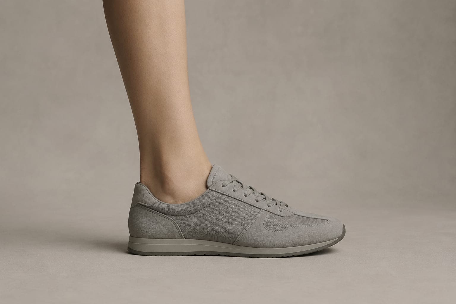 The same foot inside a shoe with an opening above the cuff height, showing no sock above the shoe.