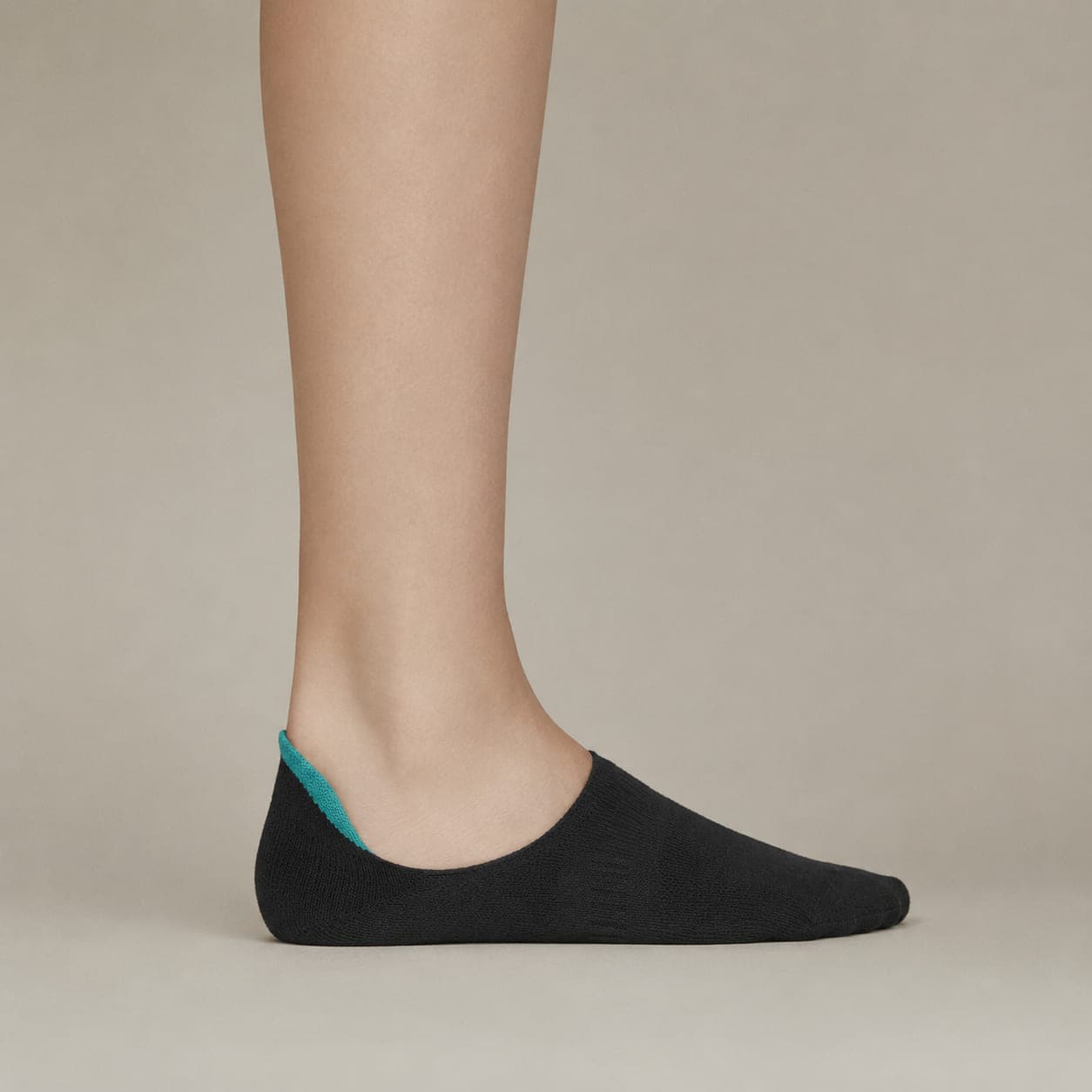 Deep 30 worn on a foot, seen from the side, with the cuff edge visible above the heel.