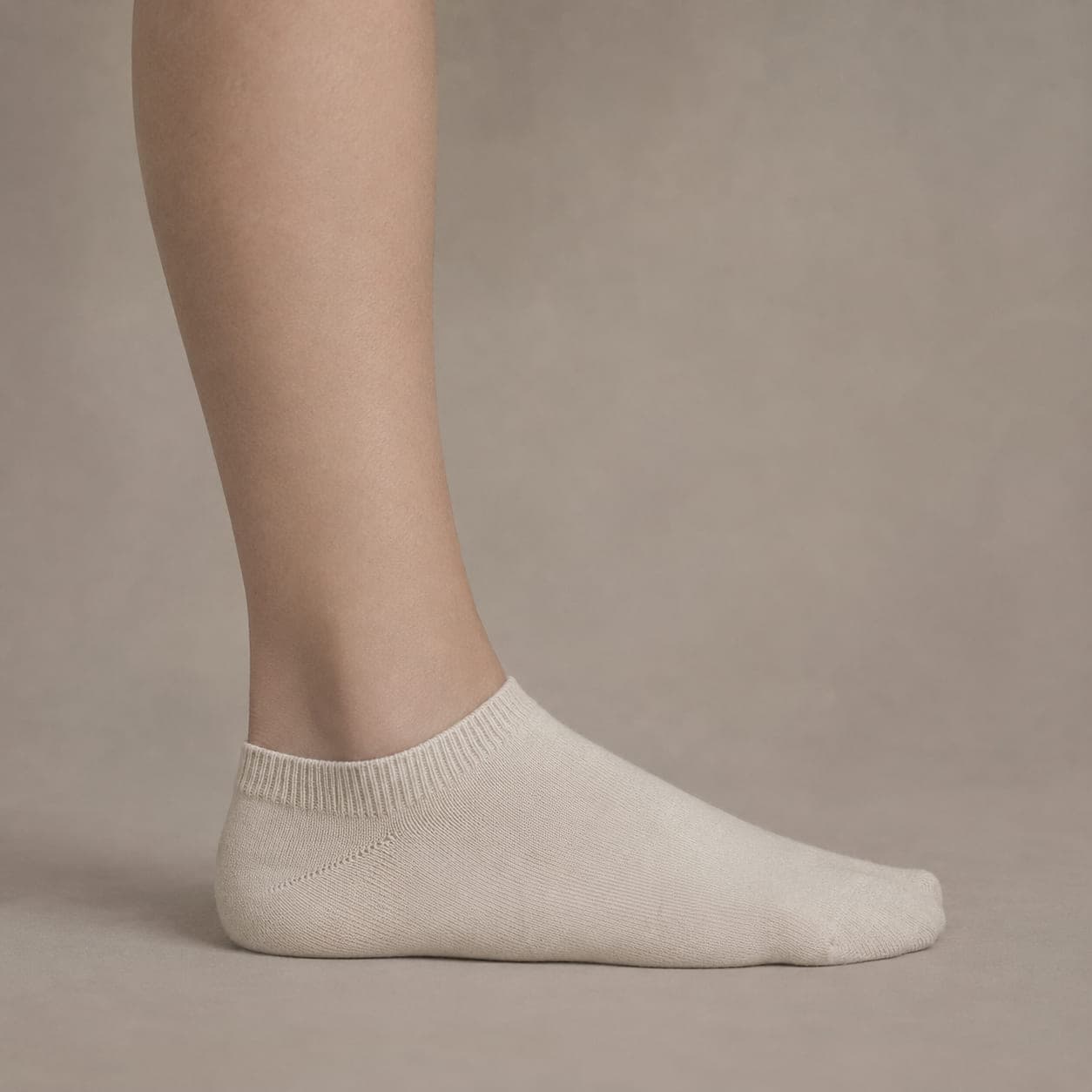 Band 42 Cotton worn on a foot, seen from the side, with the cuff edge visible above the heel.