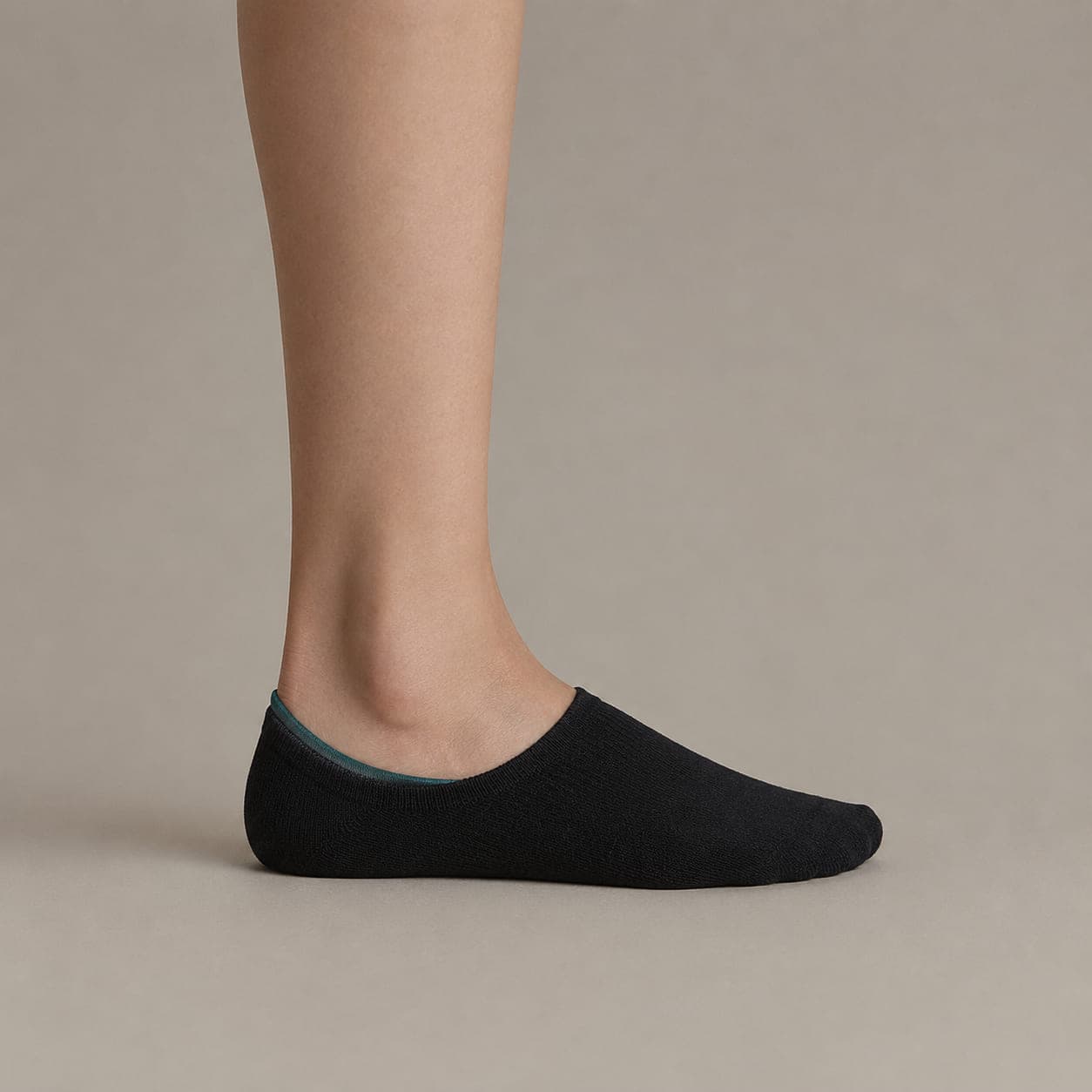 Grip Premium worn on a foot, seen from the side, with the cuff edge visible above the heel.
